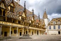 L`Hotel-Dieu or the Hospices of Beaune historic hospital, with visitors, in Beaune, Burgundy, France Royalty Free Stock Photo