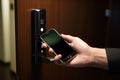 Hotel door security unlocking by application on mobile phone Royalty Free Stock Photo