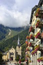 Hotel facade and the church behind in city Chamonix. Royalty Free Stock Photo