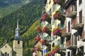 Hotel facade and the church behind in city Chamonix. Royalty Free Stock Photo