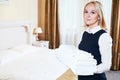Hotel female housekeeping worker charmbermaid with linen Royalty Free Stock Photo