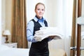 Hotel female housekeeping worker with linen Royalty Free Stock Photo