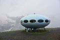 hotel is in the form of a flying saucer on the mountain, flying saucer in the mountains, UFO in the mountains