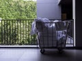 Hotel housekeeping maid laundry trolley with white used bed sheets.