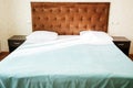 Hotel interior, room with bed and bedside table in motel Royalty Free Stock Photo