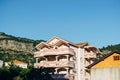 A hotel with large balconies among the mountains against a blue sky. Royalty Free Stock Photo