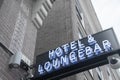 Hotel and Lounge Bar blue and white neon sign with security camera in city`s red light district