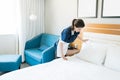 Hotel Maid Cleaning Bed In Room