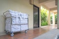 Hotel maid trolley parking front of the room with clean towel and bathrobes ready to change and make up the room