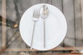 Hotel maid trolley parking front of the room with Cleaning tool cart of housekeeperPlace setting of a dining set of an empty plate Royalty Free Stock Photo