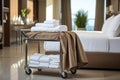 Hotel maid trolley, trolley with snow-white clean towels. Room cleaning concept. Generated by artificial intelligence Royalty Free Stock Photo