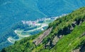 Hotel in the mountains among the green forest. Serpentine road in the mountains. Krasnaya Polyana, Sochi, Russia