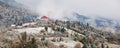 Hotel in mountains. Snow and fog. First snow in autumn.