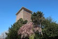 Hotel Okura in Amsterdam with blue sky and trees with blossom in spring