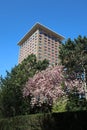 Hotel Okura in Amsterdam with blue sky and trees with blossom in spring