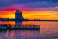 Hotel Parus in Dnipro against the background of a sunset reflected in the water of the Dnieper