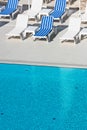 Hotel Poolside Chairs near a swimming pool Royalty Free Stock Photo