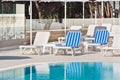 Hotel Poolside Chairs near a swimming pool Royalty Free Stock Photo