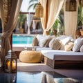 Hotel poolside lounge are with sofa with ornaments fringed pillows. Beautiful spa or wellness concept