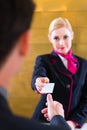 Hotel receptionist check in man giving key card Royalty Free Stock Photo