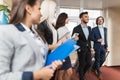 Hotel Receptionist Meeting Business People Group In Lobby Royalty Free Stock Photo