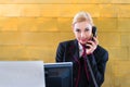 Hotel receptionist with phone on front desk Royalty Free Stock Photo