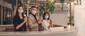 Hotel receptionist wearing medical mask and show greeting with thai wai for being new greeting practice during coronavirus covid Royalty Free Stock Photo