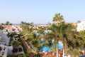 Hotel resort panorama with swimming pool, palm trees and view of the Atlantic Ocean in Playa de las Americas, Tenerife Royalty Free Stock Photo