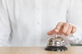 Hotel restaurant bell service on concierge customer reception counter with business person ringing pressing bell button calling Royalty Free Stock Photo