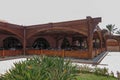 The hotel restaurant is made of wooden beams and planks. Covered outdoor terrace with seating and decorative wooden fencing.