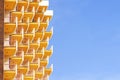 Hotel room balconies in modern building. Geometric pattern of balcony against blue sky background Royalty Free Stock Photo