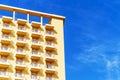 Hotel room balconies in modern building. Geometric pattern of balcony against blue sky background Royalty Free Stock Photo