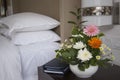 Hotel room with bed and flowers