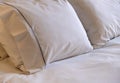 Hotel bedroom. White linen sheets and pillows on a bed Royalty Free Stock Photo