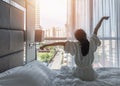 Hotel room comfort with good sleep easy relaxation lifestyle of Asian girl on bed have a nice day morning waking up Royalty Free Stock Photo