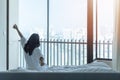 Hotel room comfort with good sleep easy relaxation lifestyle of Asian woman on bed have a nice day morning waking up Royalty Free Stock Photo