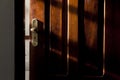 Hotel room door lock with ray of sunlight intruding from the side.