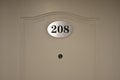 Hotel Room Door with Number 208 Royalty Free Stock Photo