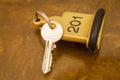 Hotel Room Key lying on Bed with keyring Royalty Free Stock Photo