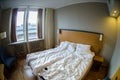 Hotel room with messed-up bed Royalty Free Stock Photo