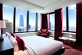 Hotel room in a skyscraper with large glass windows overlooking the city center. A romantic place full of love. Generative