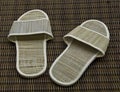 Hotel room slippers on rattan background Royalty Free Stock Photo