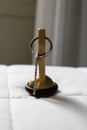 Hotel room steel key on the white bed linen Royalty Free Stock Photo