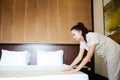 Hotel service. Made making bed in room. Royalty Free Stock Photo