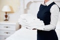 Hotel services. housekeeping maid with linen Royalty Free Stock Photo
