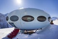 Hotel in the shape of an alien flying saucer standing high in the mountains among the snow capped mountain peaks. Dombay, Russia