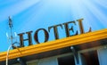 Hotel sign board on building against blue sky