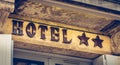 Hotel sign on a stone wall with two stars Royalty Free Stock Photo