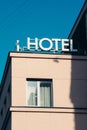 Hotel sign, word, icon, written on a rooftop of a building, vintage white letters with a window Royalty Free Stock Photo