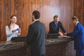 Hotel staff registering their guests Royalty Free Stock Photo